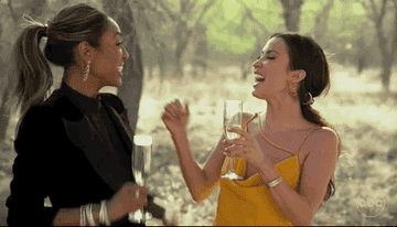 Tayshia and Kaitlyn from the bachelorette toasting with champagne