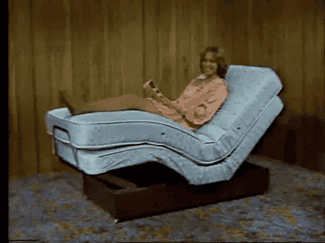 model sitting up on an adjustable bed