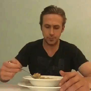 Ryan lifting his spoon to the camera then eating cereal