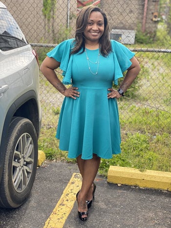 reviewer wearing the dress in teal