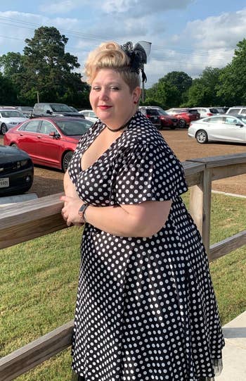reviewer wearing the dress in black with white polka dots