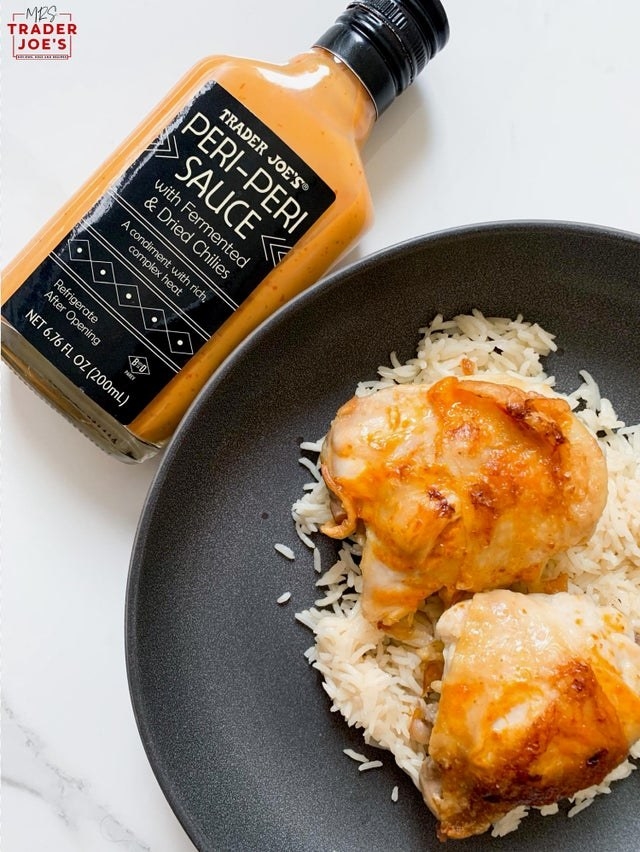 Trader Joe&#x27;s Peri Peri Sauce and plated chicken thighs over rice.