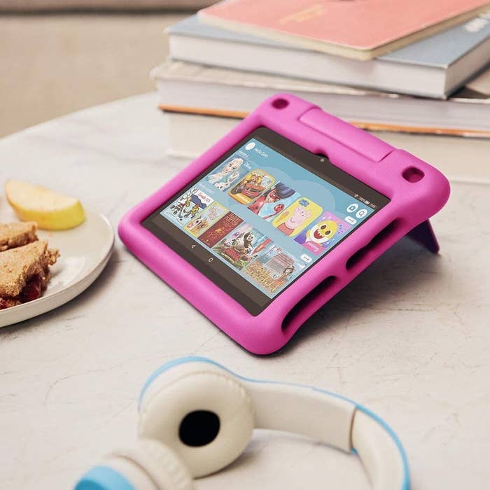 the tablet on a table next to a pair of head phones