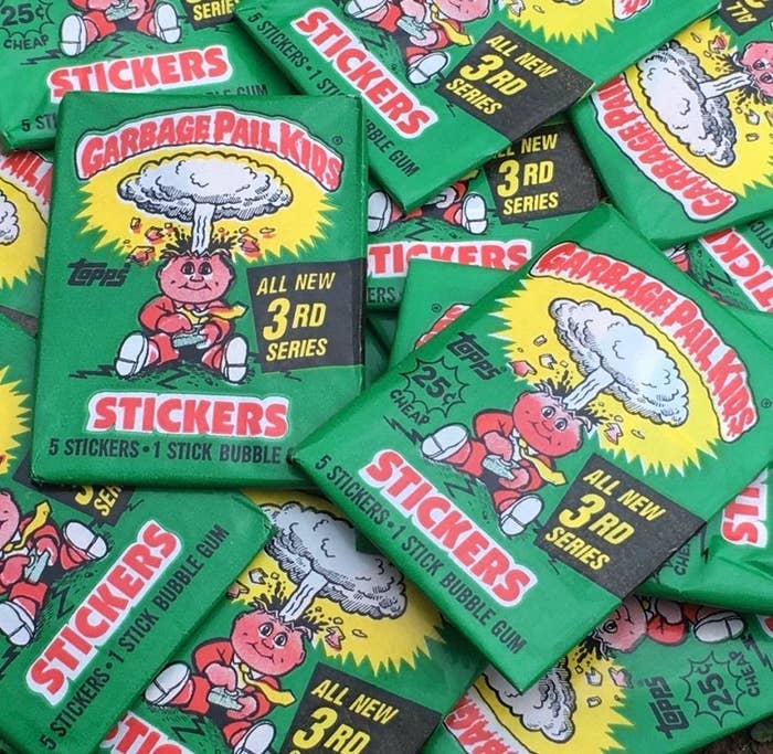 A pile of Garbage Pail Kids cards with green wrapping featuring a kid with his head exploding
