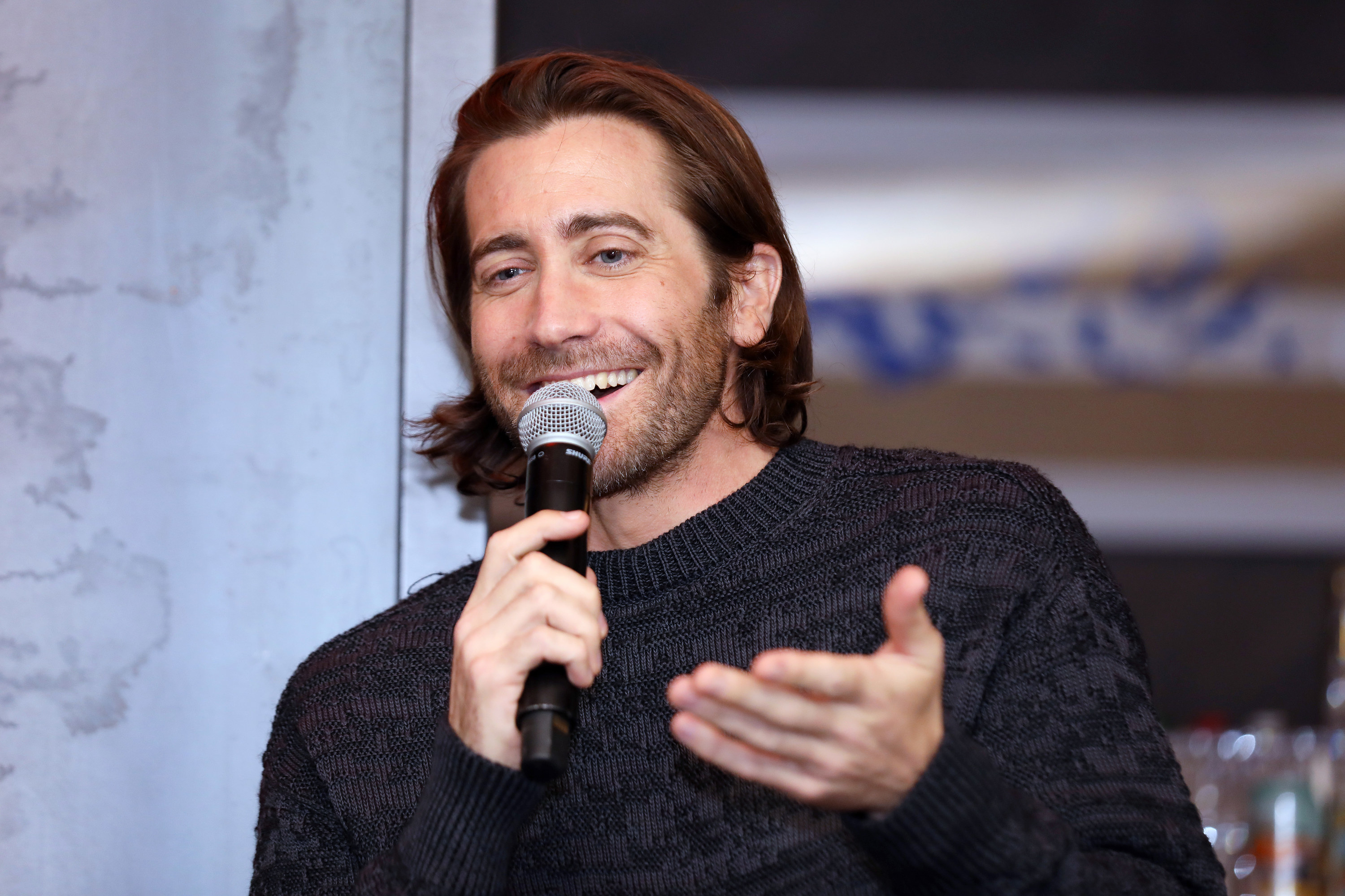 Jake Gyllenhaal speaks into a microphone at an event in 2020