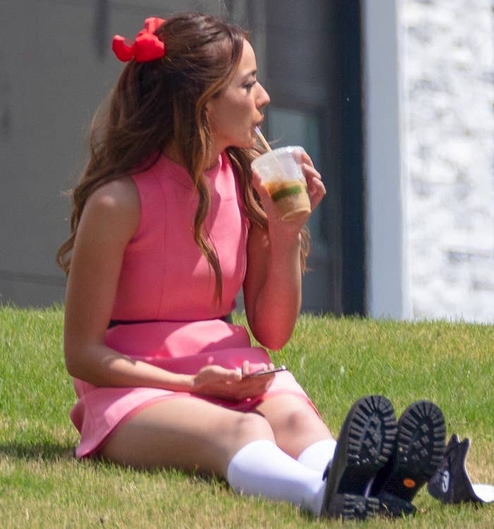 Chloe Bennet sipping a cup of iced coffee on the set of Powerpuff