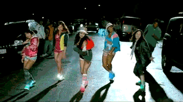 Gif of Vanessa Hudgens and backup dancers in &quot;Sneakernight&quot; music video