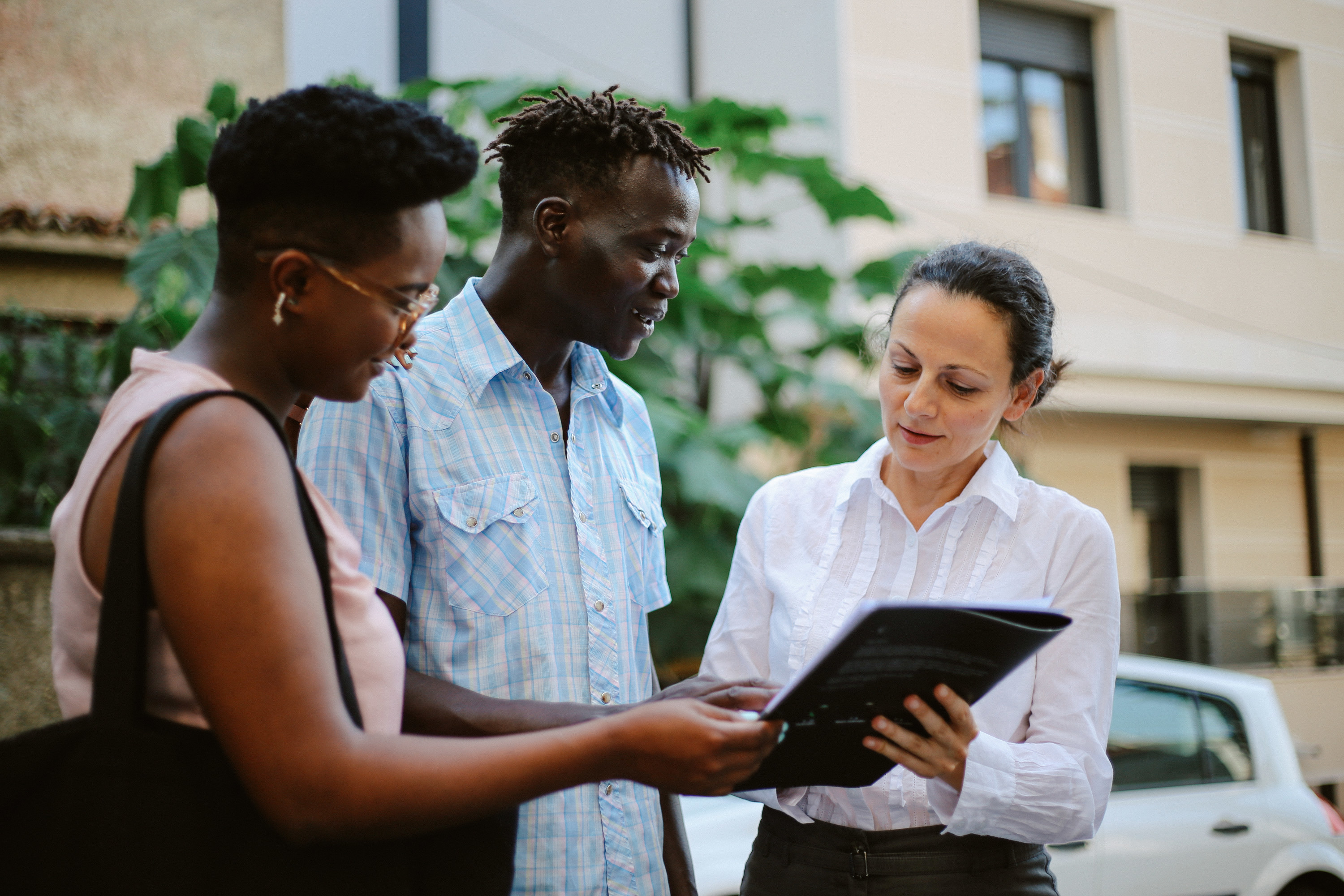 Couple looking at paperwork with a property manager