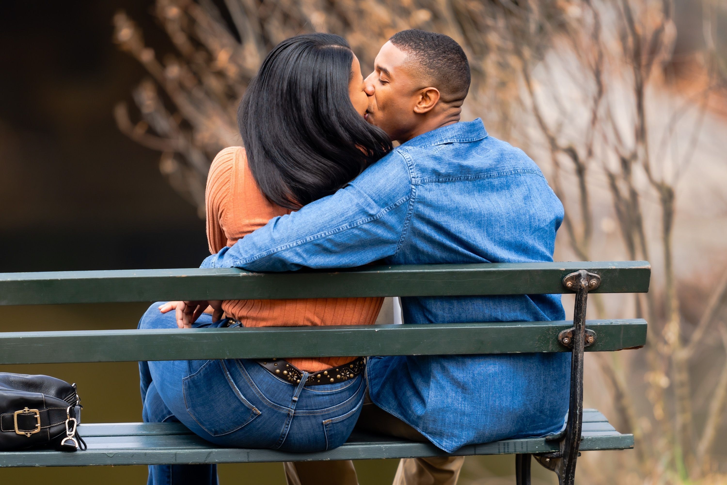 Michael&#x27;s character kissing his wife as they sit on a bench in a scene from the film