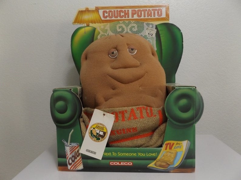 A Couch Potato stuff animal sitting on a green couch package
