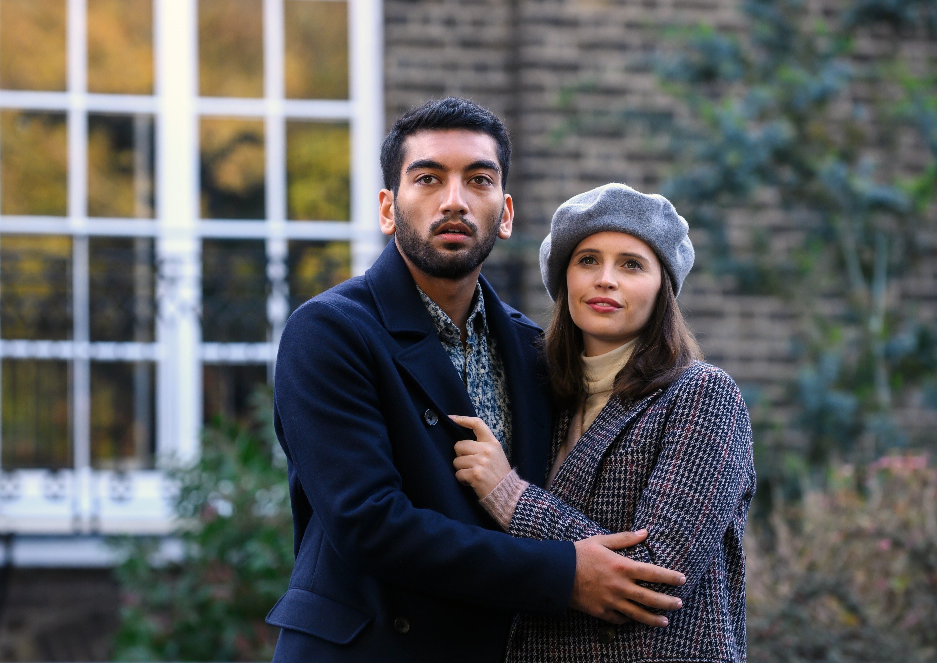 Rabhaan and Felicity embracing in front of a building