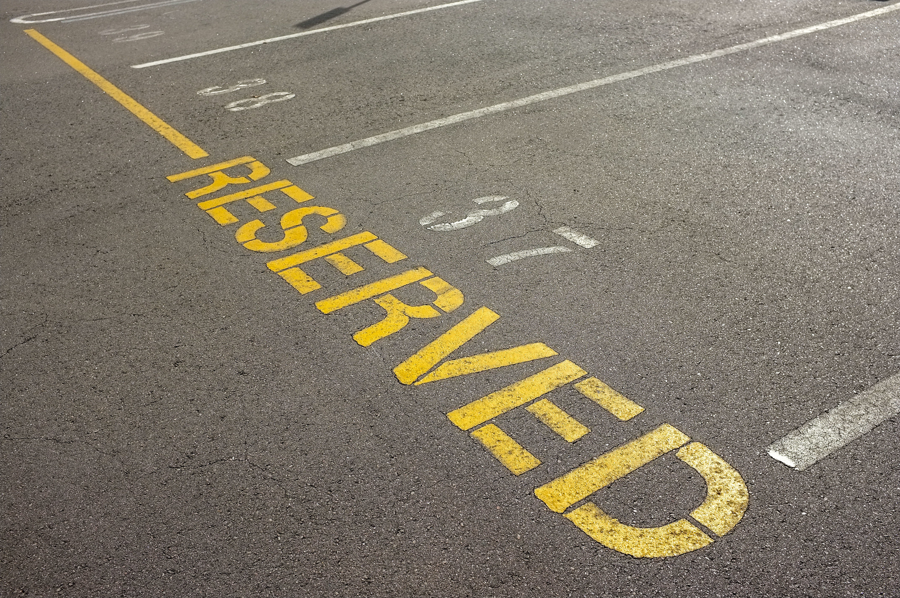 A row of reserved parking spots for tenants