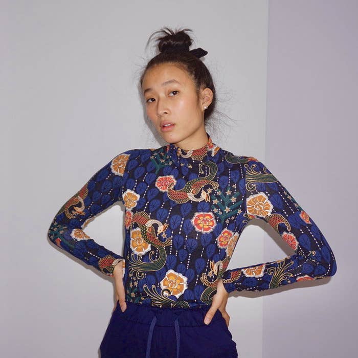 Nadya Okamoto standing against a white wall