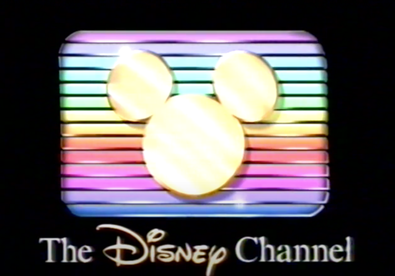1980s rainbow strips with gold mickey ears over it Disney Channel logo