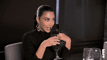 Kim and Khloë Kardashian drinking drinks and looking awkward