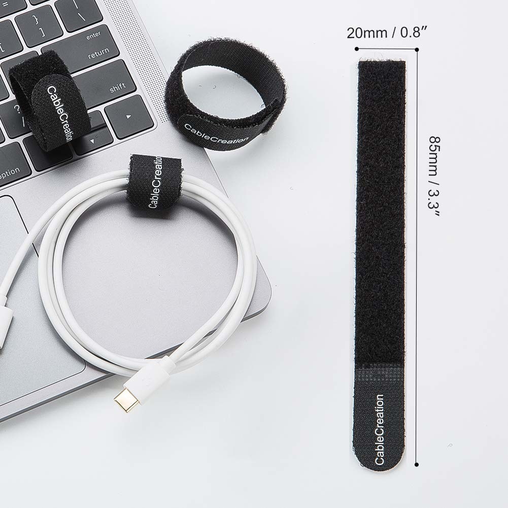 A cable organiser on a laptop with a cord in it