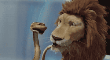 Snake holding a Lions head as they talk