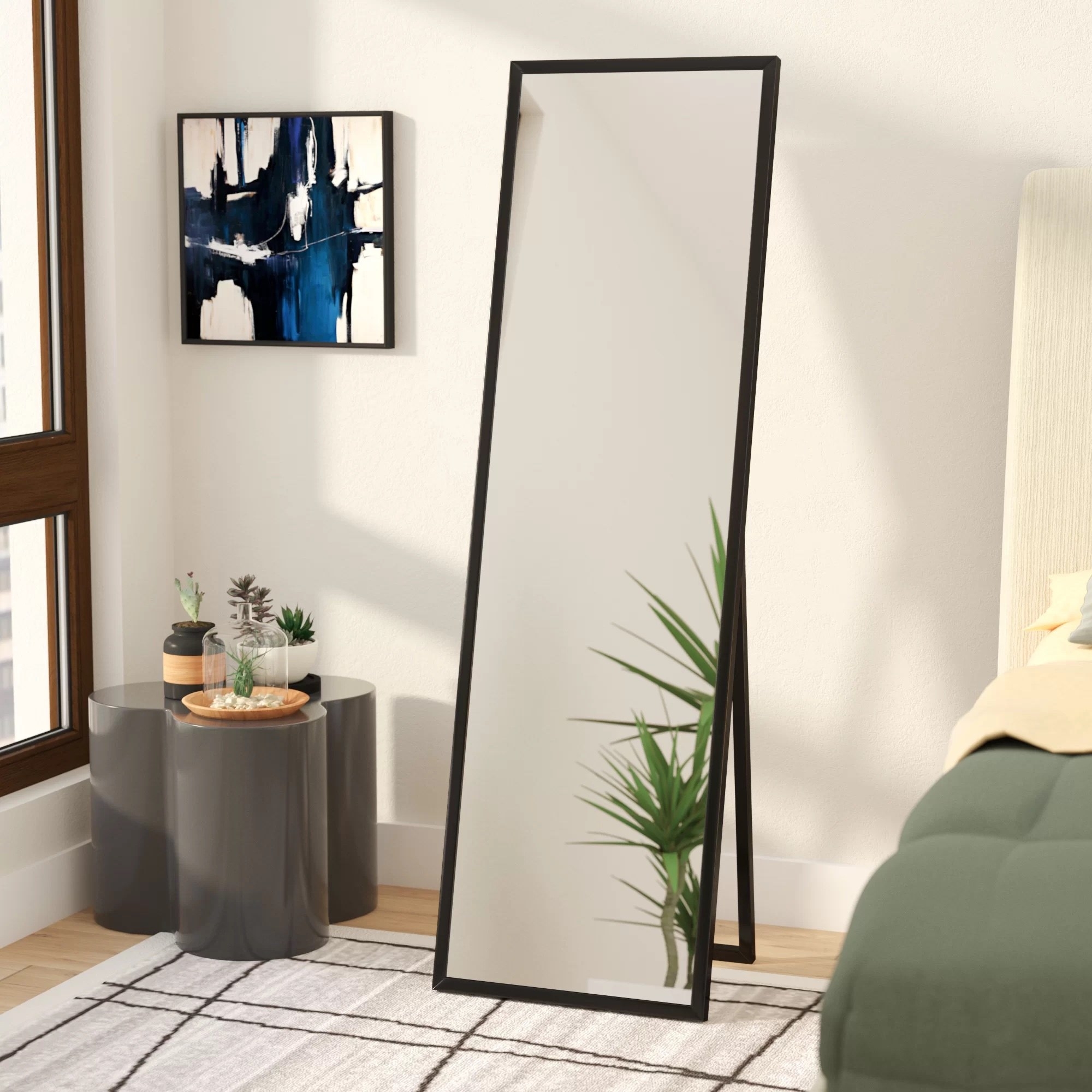 the tall standing mirror with black frame