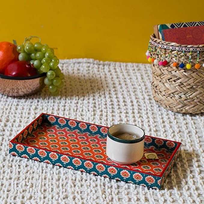 A blue and red serving tray with a traditional print