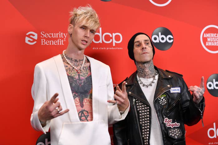 Machine Gun Kelly and Travis Barker are pictured on the red carpet at the 2020 American Music Awards