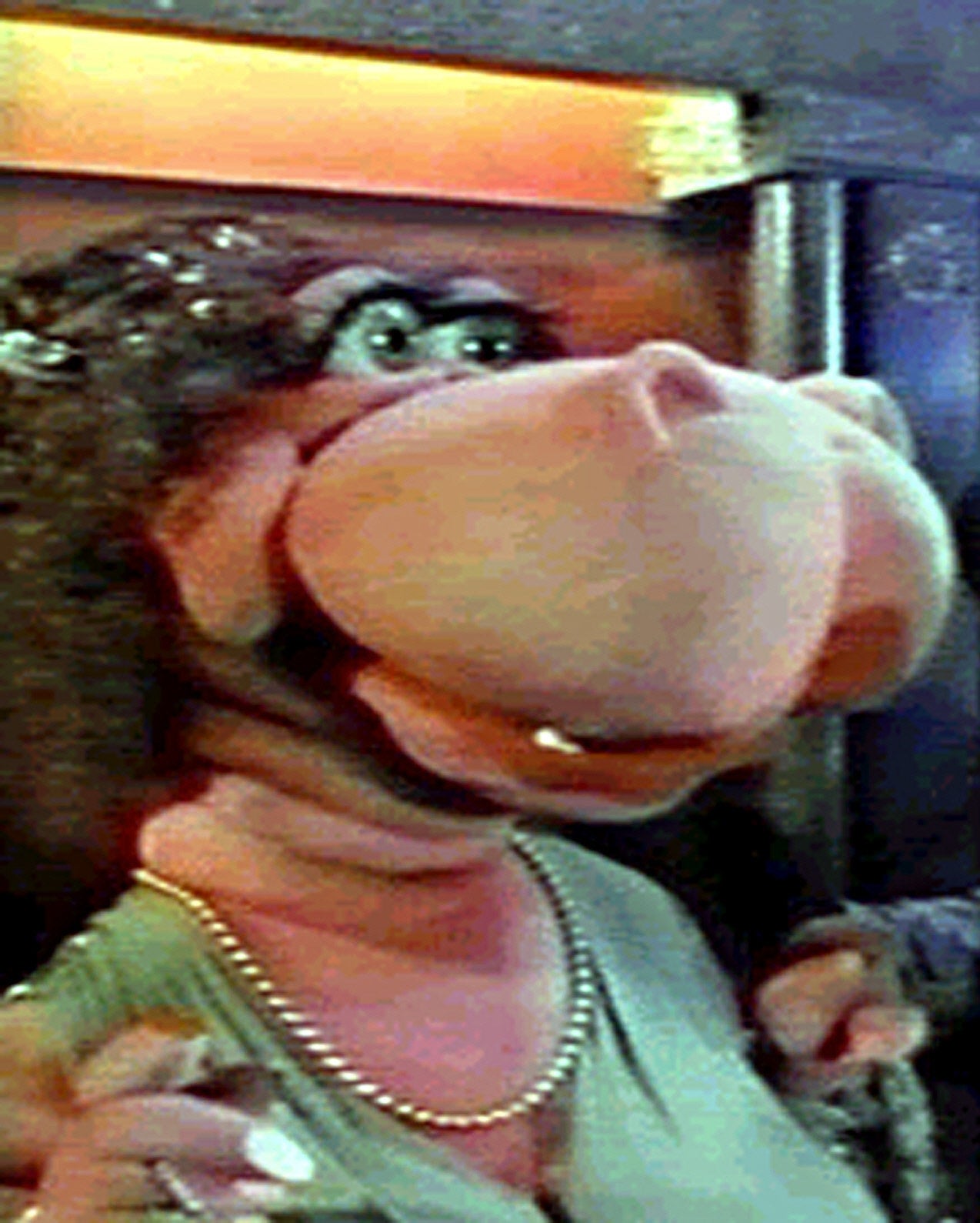 puppet with dress and pearl necklace and large snout but flesh-colored skin