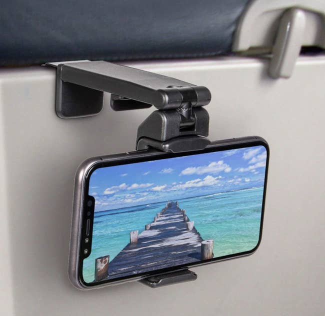 Lifestyle A phone mounted to the aid of an airplane tray desk