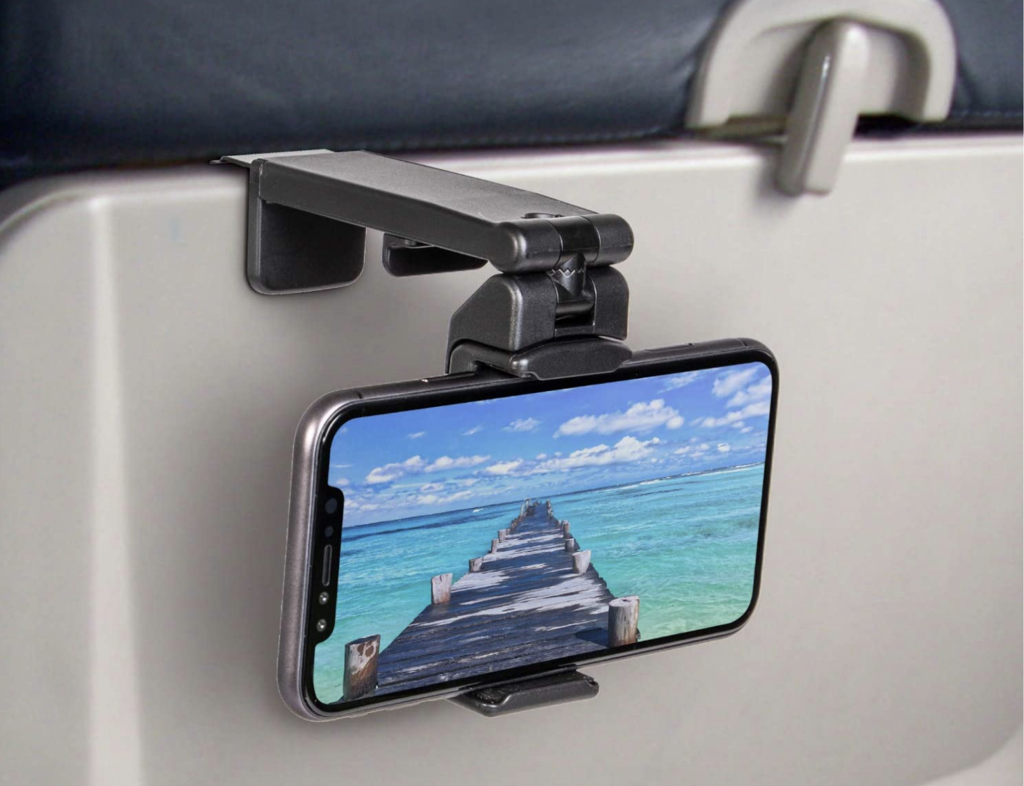 A phone mounted to the back of an airplane tray table
