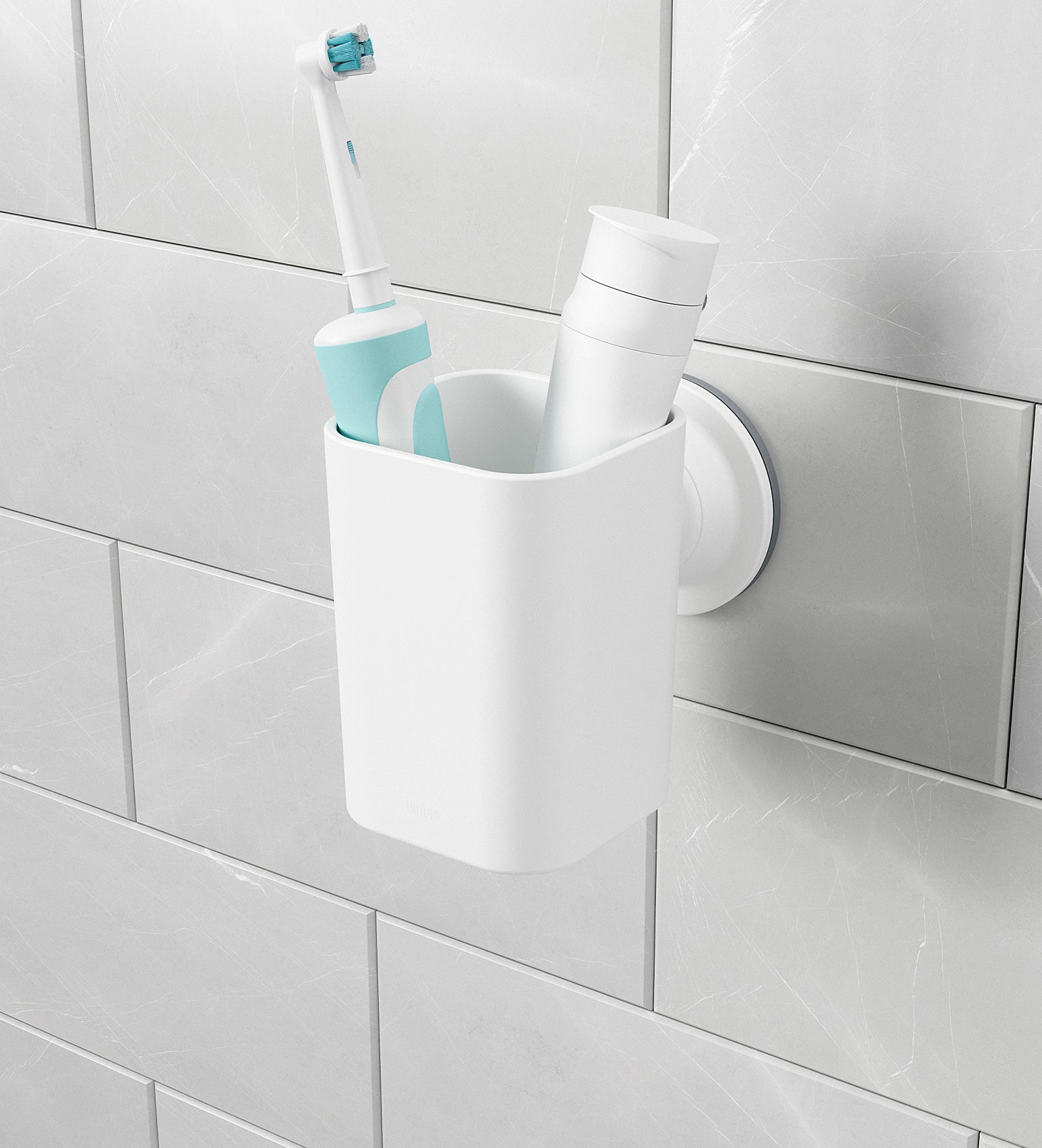 The toothbrush holder mounted via suction cup to a tiled wall