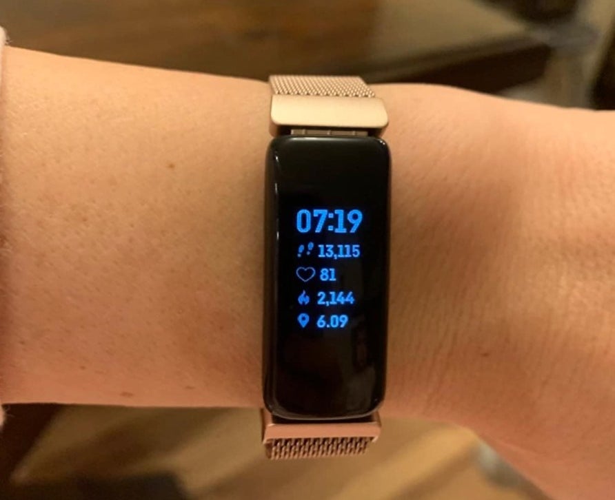 the Fit Bit in silver on a reviewer's wrist