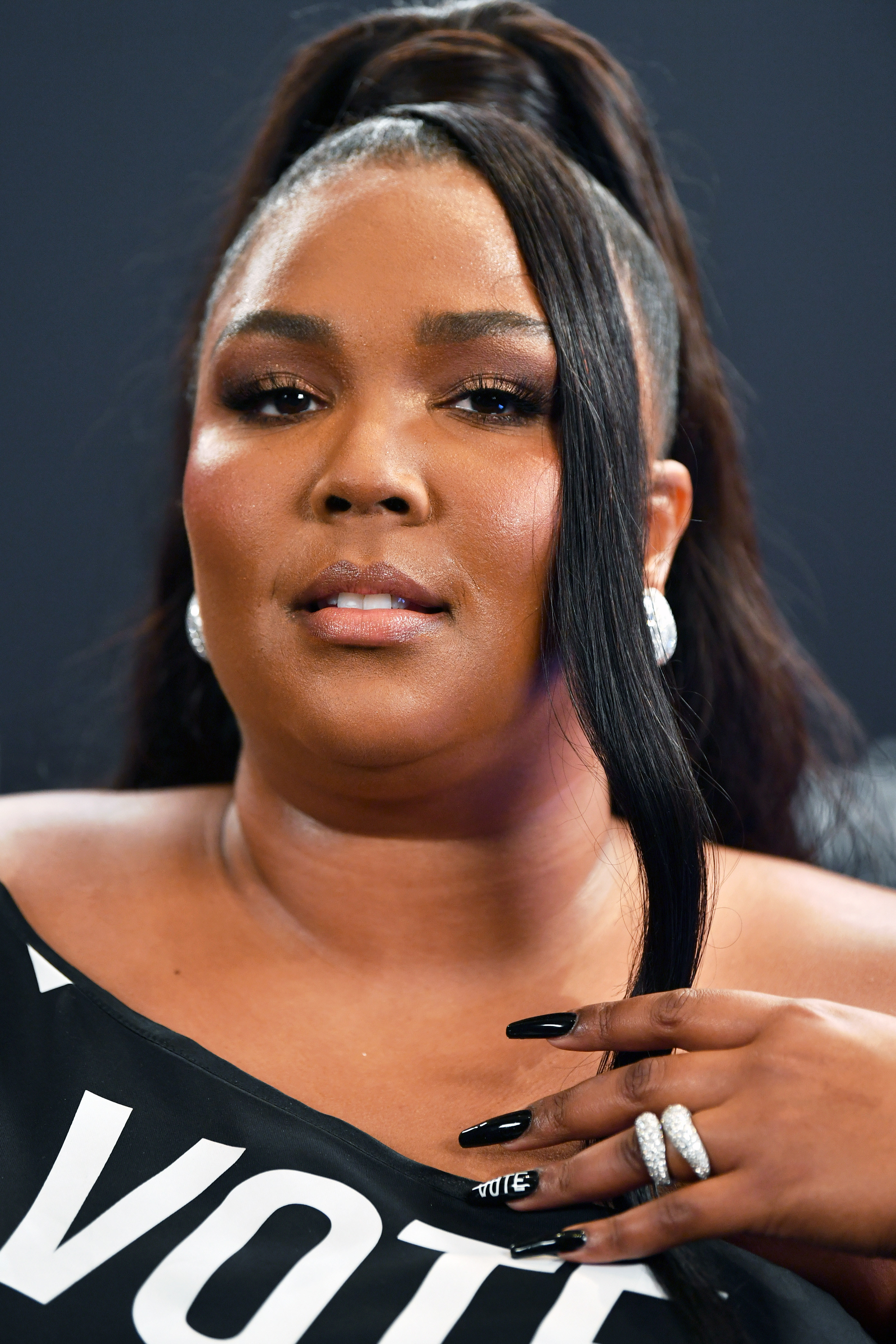 Lizzo showing off her manicure which has &#x27;Vote&#x27; written on one of her nails