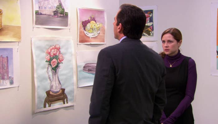 Michael looks at Pam&#x27;s watercolor paintings on the wall while Pam looks at him