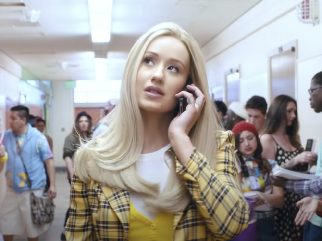 Iggy dressed up like Cher from Clueless and talking on a cellphone in the Fancy music video