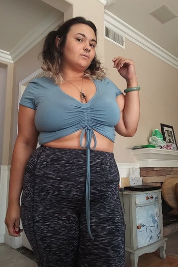 a reviewer wearing the crop top in light blue 