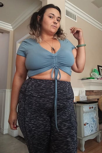 a reviewer wearing the crop top in light blue 