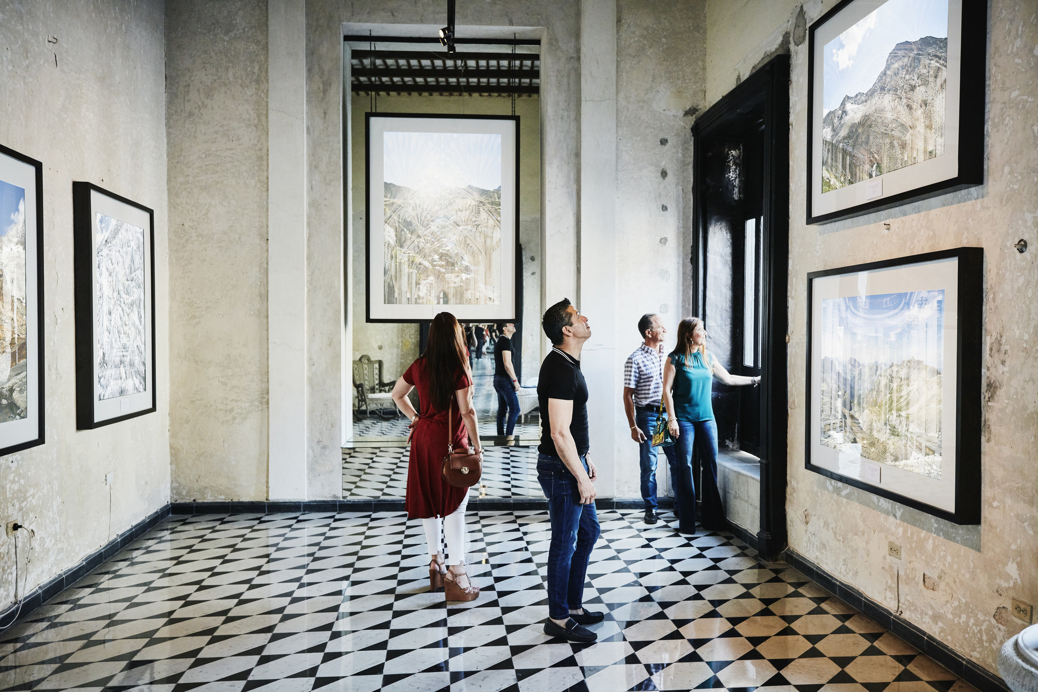 A group of tourists looking at a pictures.