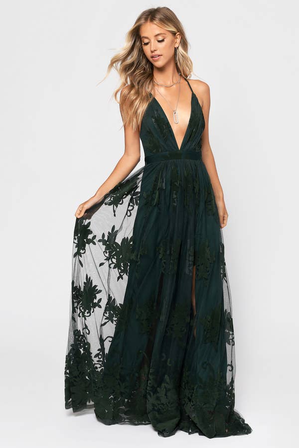 model wearing the maxi plunging v-neck dress in dark green with floral lace overlay