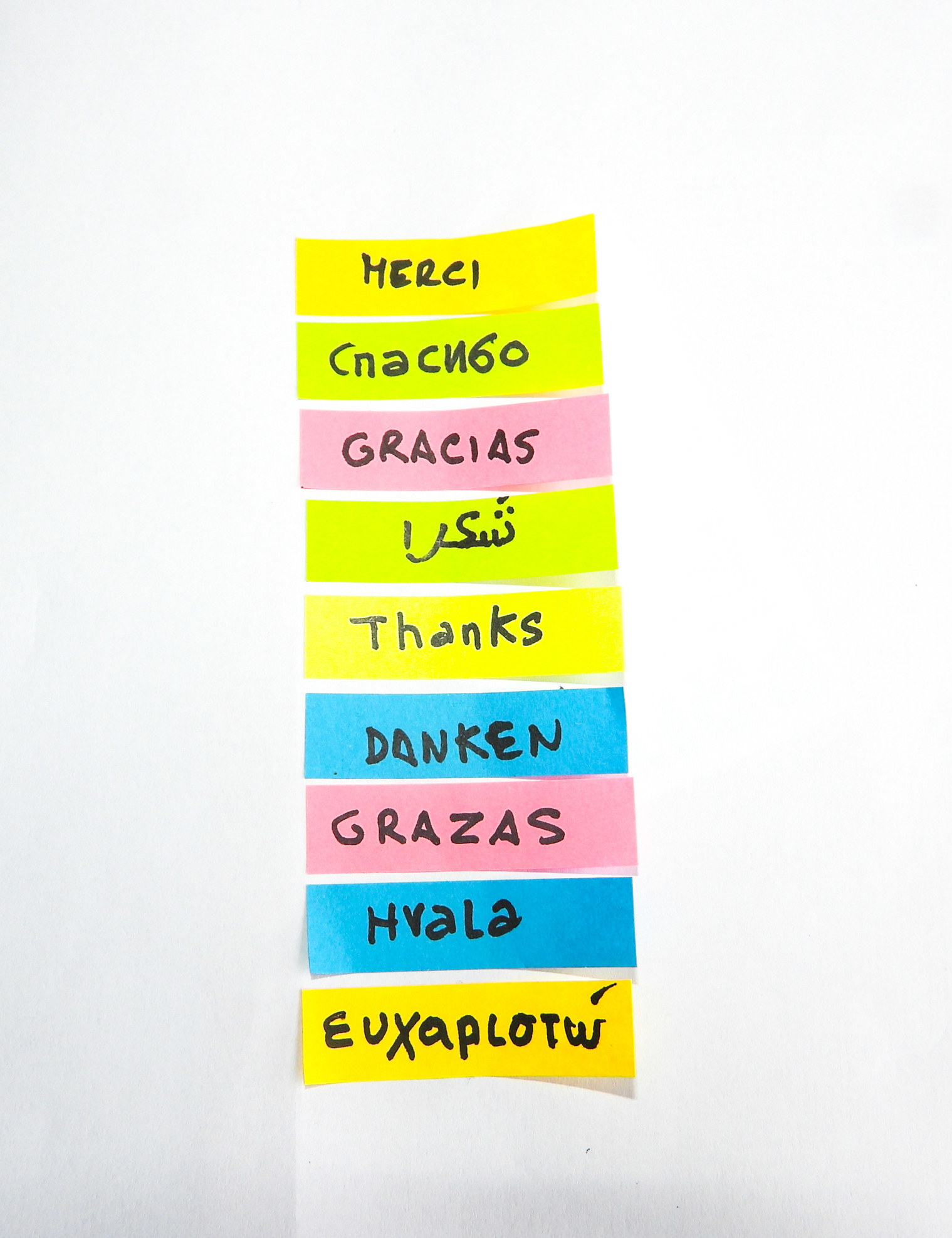 Different languages written out on post-it notes.