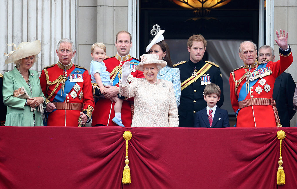 The British royal family, with Queen Elizabeth II in front, wearing a hat, and waving