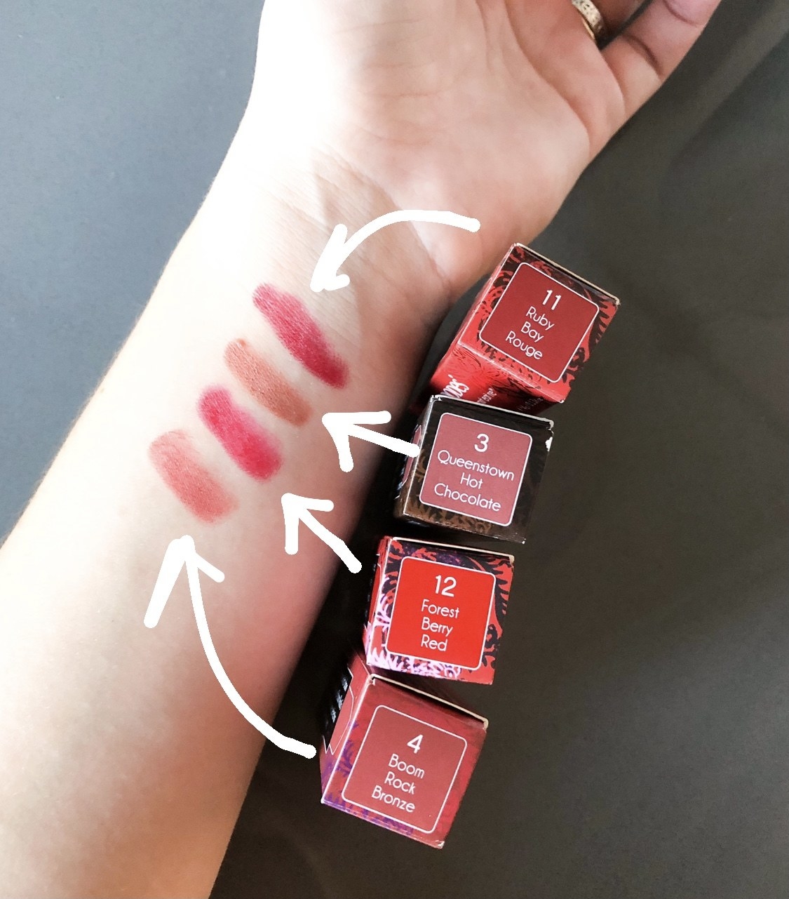 A swatching of four shades of the lipstick on the inside of someone&#x27;s arm