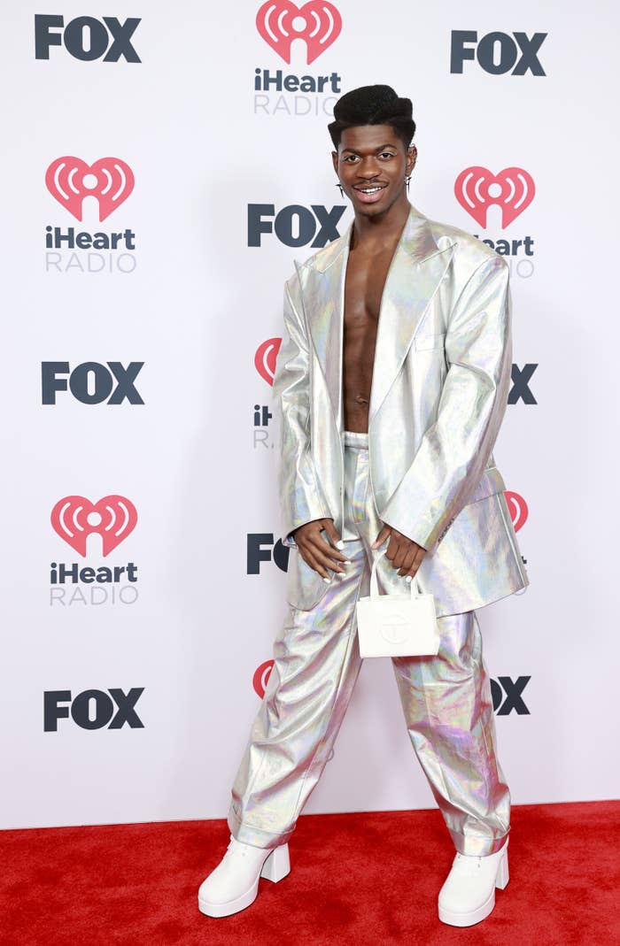 Lil&#x27; Nas X on the red carpet of an event in a metallic suit and platform heels