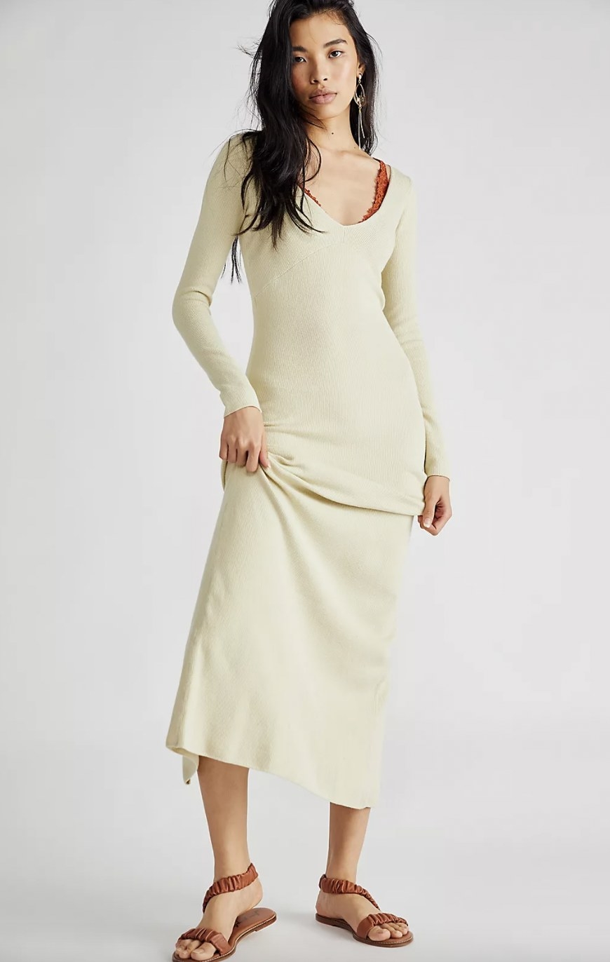 A woman wearing an off-white dress