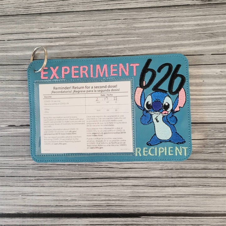 blue vaccine card holder with picture of stitch on it and text that reads experiment 626 recipient