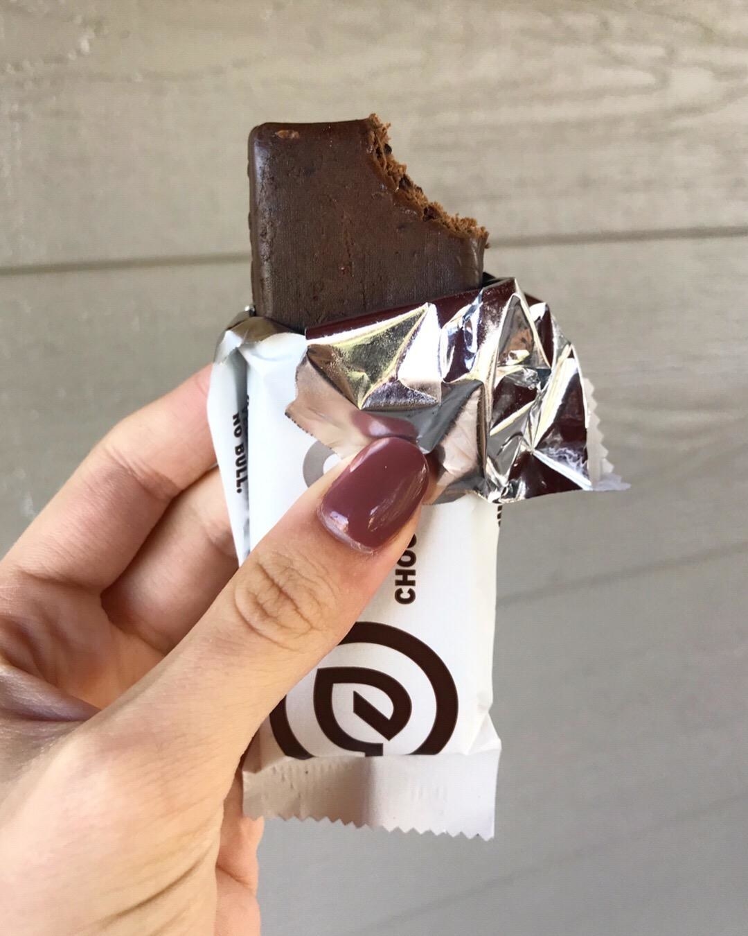 A person holding a protein bar