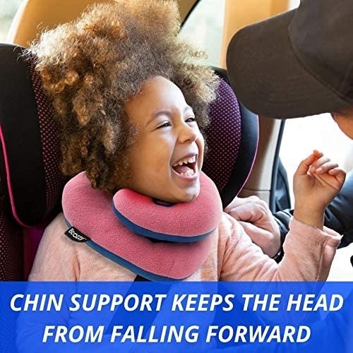 A model wearing the neck pillow in a car seat with the words "Chin support keeps the head from falling forward" on the image