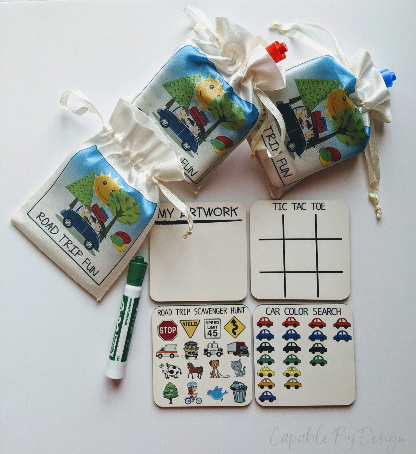 Four square boards with different games, a marker, and pouches