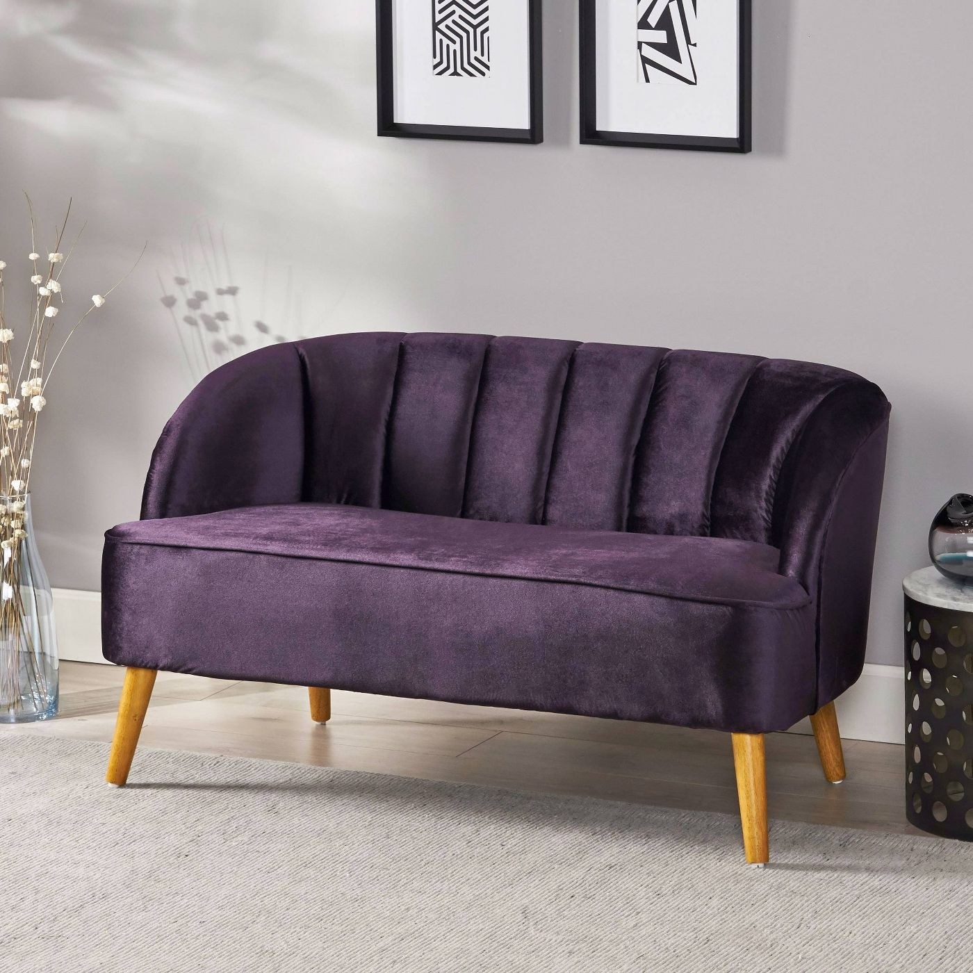 Purple velvet settee in a living room.