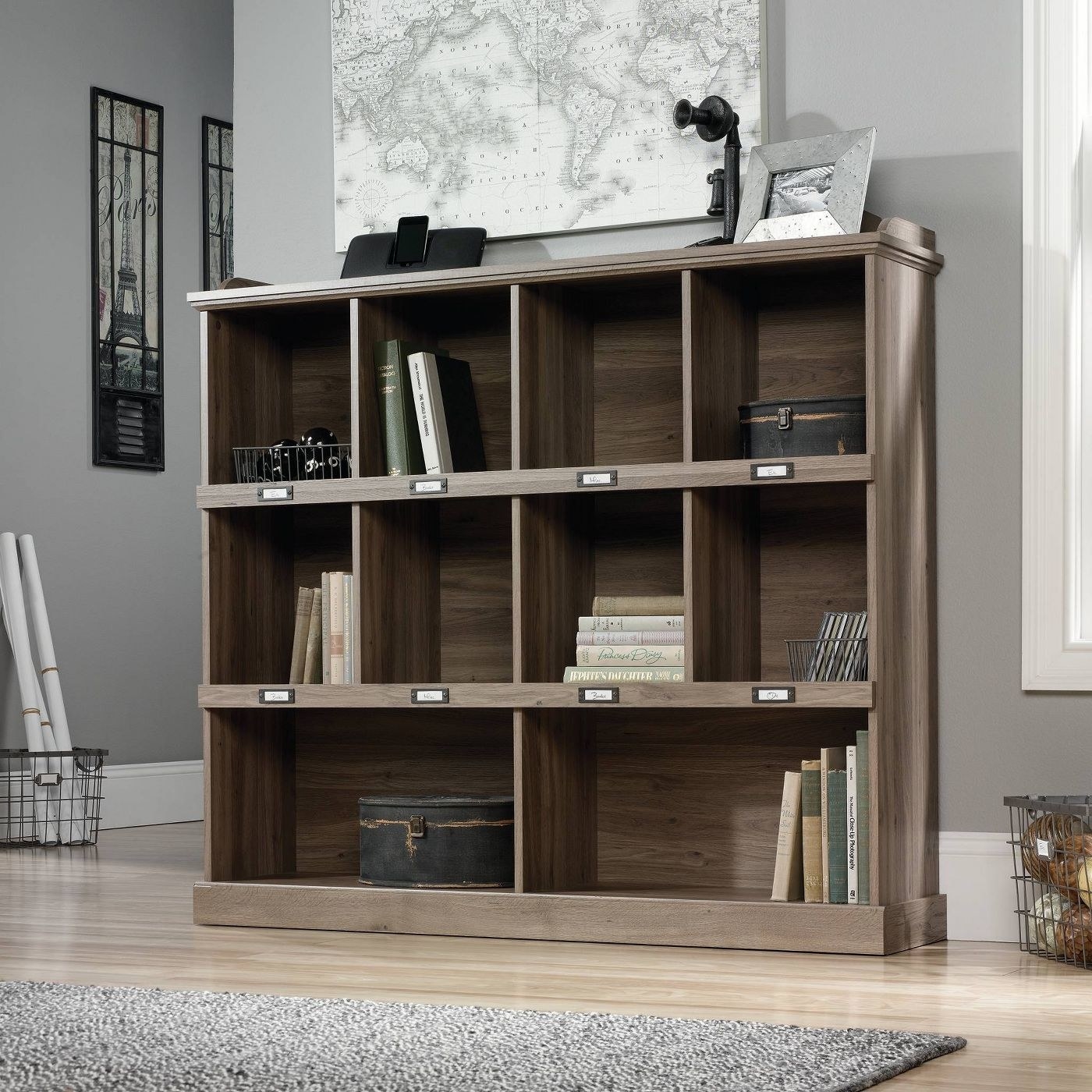 The bookshelf in a living room with multiple items inside it.