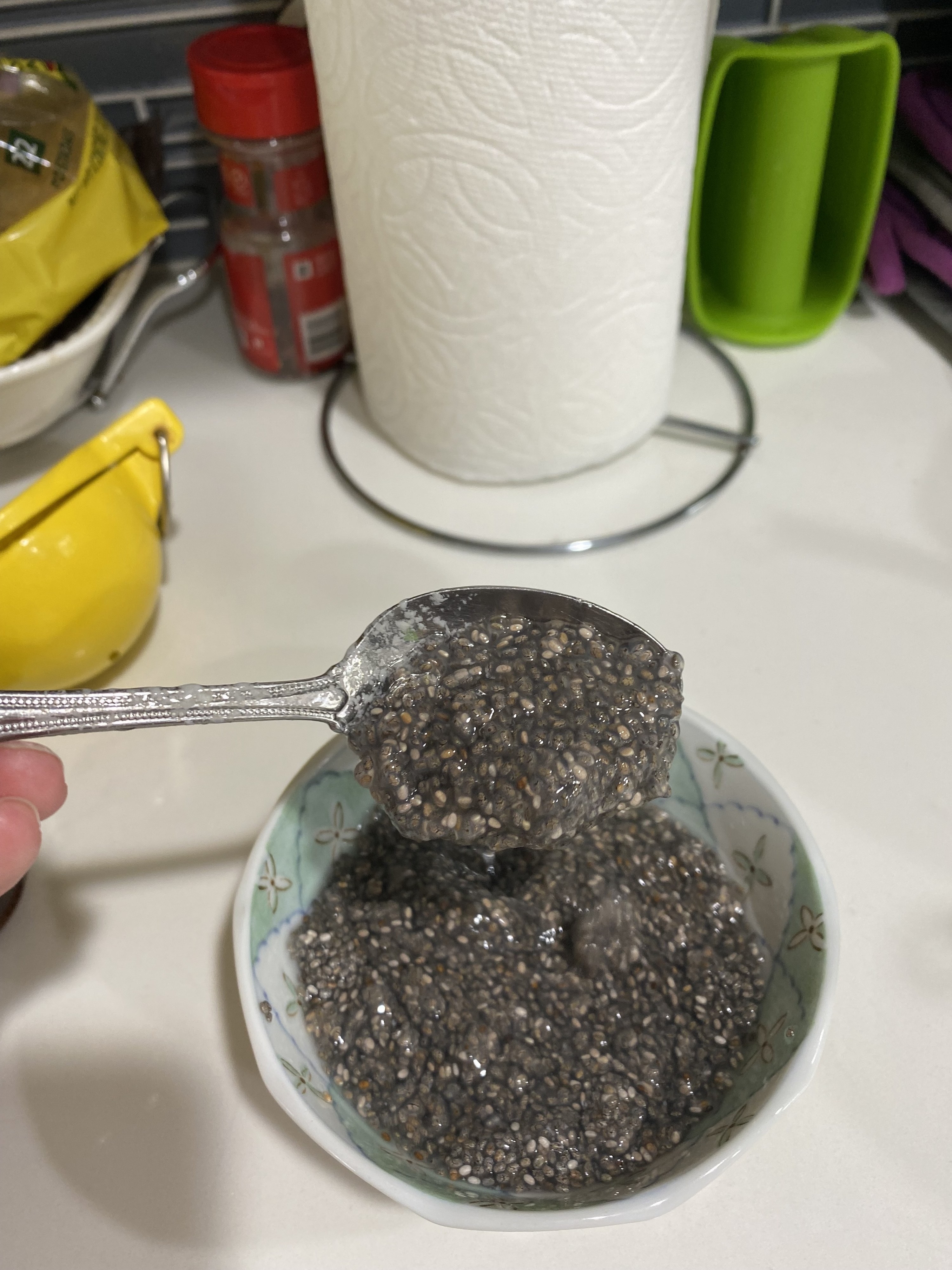 A close up of a spoonful of the &quot;chia egg&quot; which looks like a chia seed jelly
