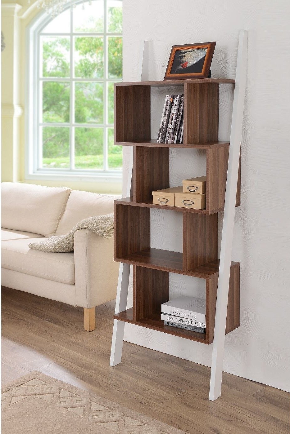 The bookshelf against a wall with various items inside.