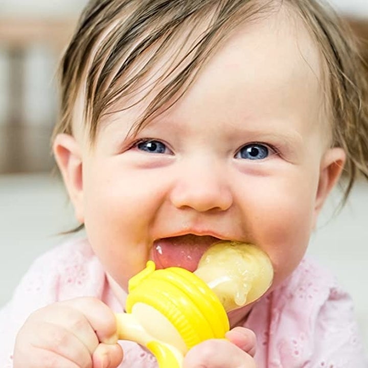 Baby chewing on the food feeder pacifier